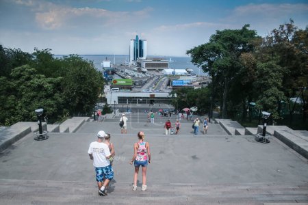Photo for ODESSA, UKRAINE - AUGUST 6, 2014: Selective blur on ukrainian people, going down Potemkin stairs, one of the landmarks of Odessa, Ukraine, in front of the black sea and the port of odessa. - Royalty Free Image