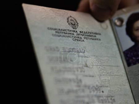 Photo for BELGRADE, SERBIA - APRIL 23, 2023: Selective blur on blurred personal data of a Yugoslav Identity Card (Licna Karta in cyrillic) with the coat of arms of Socialist republic of Yugoslavia (Jugoslavija). - Royalty Free Image