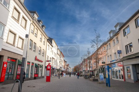 Photo for TROISDORF, GERMANY - NOVEMBER 12, 2022: Panorama of Kolner strasse of Troisdorf, a typical german main street in suburban environment with people walking passing by shops and stores, in the suburbs of Cologne. - Royalty Free Image