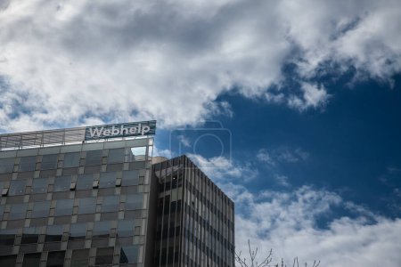 Photo for BUCHAREST, ROMANIA - MARCH 13, 2023: Logo of Webhelp Romania on their headquarters in Bucharest. Webhelp is a company proving call center services an customer care outsourcing. - Royalty Free Image