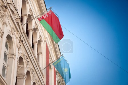 Photo for Selective blur on the flags of Belarus and Kazakhstan waiving together in the air in Belgrade streets. Belorussia and Kazakhstan are two former soviet states, part of CIS, Commonwealth of Independent States. - Royalty Free Image