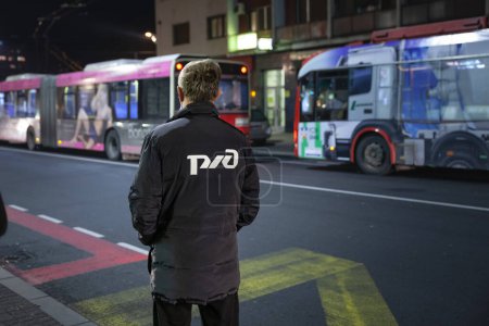 Photo for BELGRADE, SERBIA - DECEMBER 31, 2021: man wearing a coat with the RZHD logo in belgrade. Called RZD or rossiyskie zheleznye dorogi, it's the Russian railways company, owned by the Russian government. - Royalty Free Image