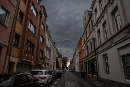Photo for COLOGNE, GERMANY - NOVEMBER 6, 2022: Typical street of Nippes, with multistorey residential buildings in Koln, or Cologne, with cars parked on sides of the street. - Royalty Free Image