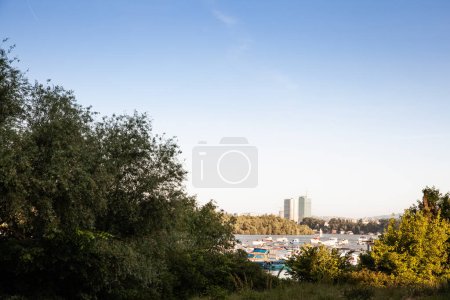 Photo for Panorama of boats anchored on the sava river by the veliko ratno ostrvo island with the Usce towers, Usce 1 and 2 in New Belgrade. in background These are a mixed used business high rise skyscraper. - Royalty Free Image