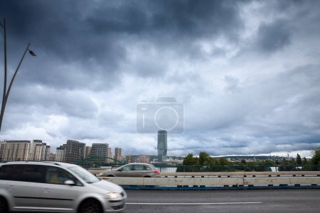 Photo for BELGARDE, SERBIA - AUGUST 8, 2023: Selective blur on cars passing on Branov Most bridge in front of Belgrade waterfront, or Beograd na vodi, behind. It's a controversed luxury real estate project. - Royalty Free Image