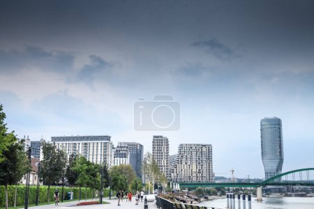 Photo for BELGRADE, SERBIA - SEPTEMBER 3, 2023: skyline of Belgrade, over the sava river in a cloudy sky with Belgrade waterfront, or Beograd na vodi, behind seen from Sava promenada, a walking area. - Royalty Free Image