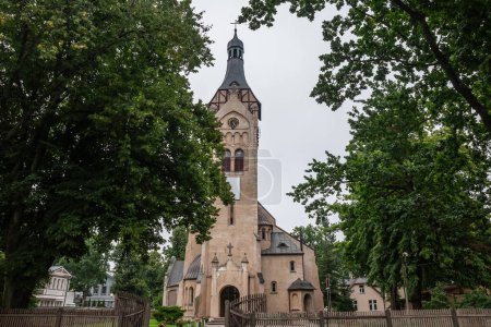 Photo for Main facade and steeple of the dubulti lutheran evangelical church in Jurmala. It's a major protestant lutheran church of Latvia, in the baltic states. - Royalty Free Image