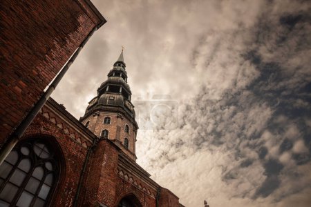 Photo for Main tower of Riga Church of Saint Peter at dusk. Saint Peter Church Cathedral also called Sveta Petera Evangeliski luteriska baznica, it is a evangelical lutheran protestant church of latvia, in Riga. - Royalty Free Image