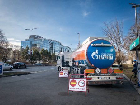 Photo for BELGRADE, SERBIA - FEBRUARY 7, 2024: Gazprom logo on a truck, fuel tanker, in a gas station of Belgrade, Serbia supplying oil. Gazprom is a russian producer & seller of oil & other petroleum products. - Royalty Free Image
