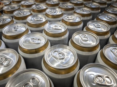 Selective bur on aluminum cans, beer cans, stacked and packaged in a warehouse, ready for shipment and logistics expedition in a soda and beverage production facility.