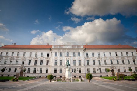 Panorama of the Kossuth ter square of Pecs, Hungary, with the baranya county government building and the Kossuth lajos statue designed in 1908 by Lajos Horvay. It's a major landmark of pecs.