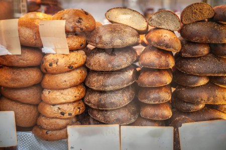 Photo for Assortment of fresh Latvian rye bread, known as 'Rupjmaize', on display at a Riga market. Bread, especially rye, is a tradition of the latvian cuisine. - Royalty Free Image