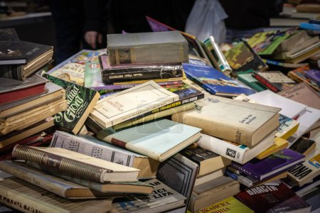 Photo for BELGRADE, SERBIA - OCTOBER 30, 2023: Selective blur on piles of second hand books, old books of serbian literature, in serbian language, for sale in an old bookstore of Belgrade. - Royalty Free Image