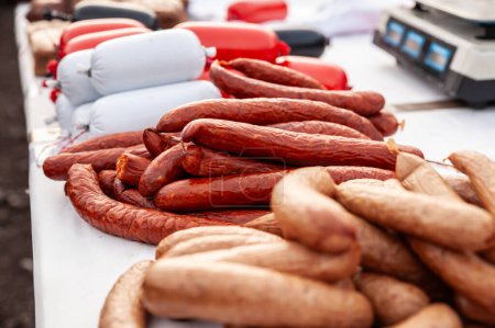 Selective blur on various serbian sausages, called kobasica, for sale in a market of Serbia in Belo blato, with various prices. Serbia is a huge meat producer.