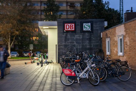 Photo for COLOGNE, GERMANY - NOVEMBER 12, 2022: entrance to koln mulheim bahnhof in Cologne with bicycles parked in front at night. It's a major train station of the Cologne S-Bahn suburban system. - Royalty Free Image