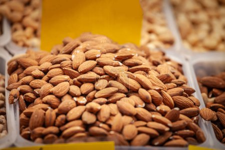 Selective blur on dry almonds for sale in a market of Belgrade, ready for prices to be negotiated. Almond, or prunus dulcis, is a dried fruit and a commodity.