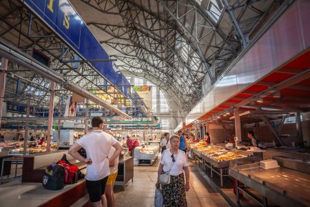 Photo for RIGA, LATVIA - AUGUST 23, 2023: Panorama of the main aisle of the fish pavilion (zivju paviljons) of Centraltirgus, Riga Central market, a landmark and a symbol of latvian economy with clients. - Royalty Free Image