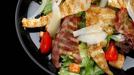 Caesar salad topped with crispy bacon