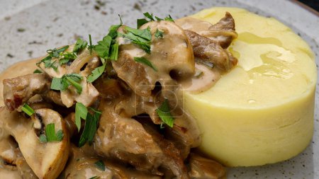 Mashed potatoes with sauce and mushrooms