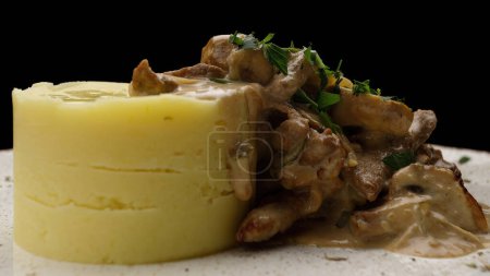 Mashed potatoes with sauce and mushrooms