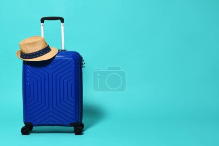 Photo for Blue trolley travel bag with hat - Royalty Free Image