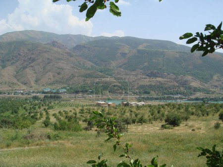a view of the mountain where a river flows at the foot of the mountain
