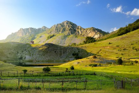 Photo for Scenic landscape of mountain valley with Bukumirsko Lake in alps of Montenegro. Stunning view of mountains and valleys in sunset light. Hiking and tracking concept - Royalty Free Image