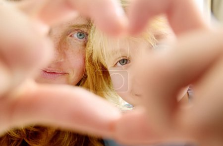 Photo for Gesture heart with hands mother and son. It often using for logo of protection for family and childhood funds, healthcare and custody of kids leaves without parent. It is symbol of kind, help, charity - Royalty Free Image