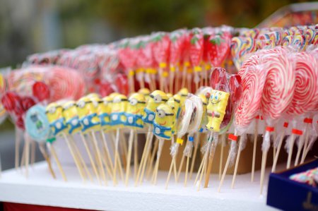 Photo for Serbia, Belgrade - April, 8, 2023: Closeup of lollipops in the shape form of cartoon characters and candy on a stick for sale the Vrbica orthodox holiday at street market in Beograd. - Royalty Free Image