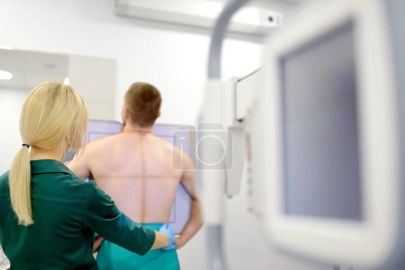 Die Radiologin macht im Röntgenraum einer modernen Klinik ein Röntgenbild der Lungen der Patientin. Arzt führt eine Fluorographie durch. Medizinische Untersuchung von Menschen ist Vorbeugung gegen die weltweit verbreitete Tuberkulose
