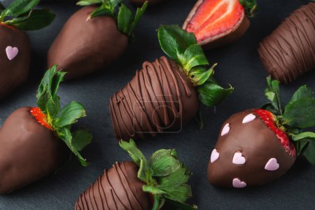 Gourmet chocolate covered strawberries on the dark background.