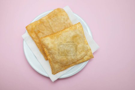 Foto de Typical brazilian fried pastry on white small plate - Imagen libre de derechos