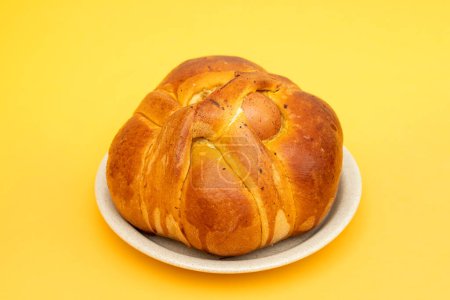 Fresh portuguese Easter folar with egg on white dish