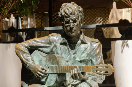 Photo for ALMERIA, SPAIN - 02 APRIL 2023 A sculpture of John Lennon which is a tribute to the artist who in 1966 lived in Almeria and was filming in the nearby desert of Tabernas the role of Private Gripweed in the black comedy How I Won the War - Royalty Free Image