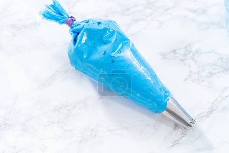 Photo for Buttercream frosting in a piping bag for decorating a cake. - Royalty Free Image