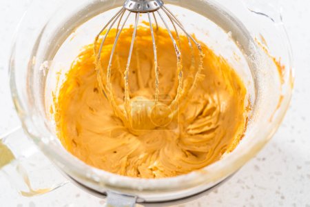 Freshly whipped dulce de leche buttercream frosting in a glass bowl.