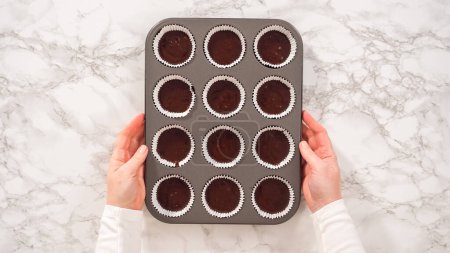 Flat lay. Step by step. Baking chocolate cupcakes. Scooping chocolate cupcake batter into a cupcake pan.