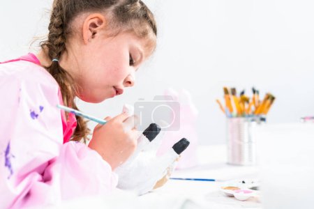 Photo for Little girl working on her art project for distance learning at home during COVID-19 pendemic. - Royalty Free Image