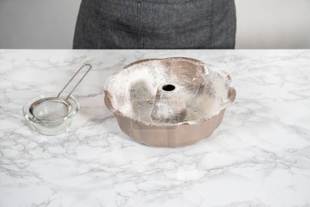 Photo for Greasing metal bundt baking pan to bake bundt cake. - Royalty Free Image