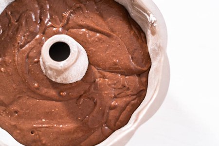 Photo for Chocolate cake batter in a metal bundt cake pan ready for baking. - Royalty Free Image