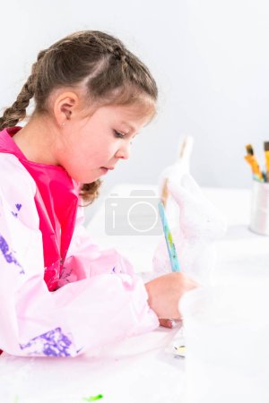 Photo for Little girl working on her art project for distance learning at home during COVID-19 pendemic. - Royalty Free Image