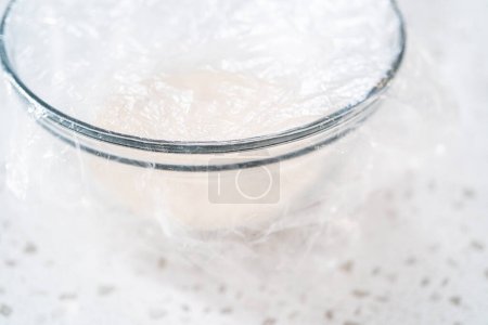 Photo for Activating dry yeast in a glass mixing bowl to bake naan dippers. - Royalty Free Image