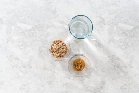 Photo for Flat lay. Measured ingredients in glass mixing bowls to prepare boba pearls. - Royalty Free Image