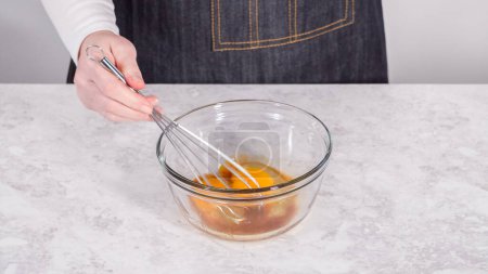 Téléchargez les photos : Pas à pas. Mélanger les ingrédients dans un bol de mélange en verre pour préparer des crêpes à la banane à la noix de coco. - en image libre de droit