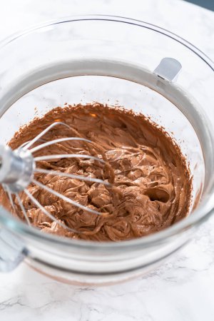 Téléchargez les photos : Fouetter la ganache au chocolat avec un mélangeur de cuisine électrique. - en image libre de droit