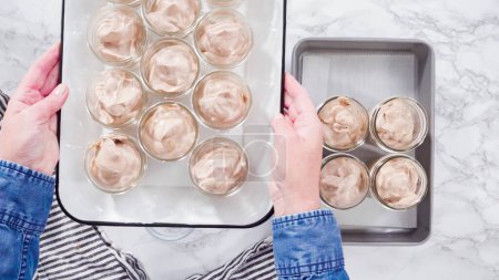 Téléchargez les photos : Pose plate. Pas à pas. Ramasser la crème glacée au chocolat maison dans des bocaux en verre. - en image libre de droit