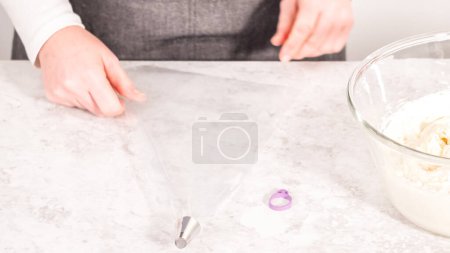 Photo for Step by step. White buttercream frosting in a piping bag with a metal tip. - Royalty Free Image