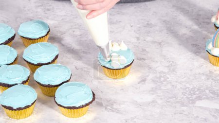 Téléchargez les photos : Pas à pas. Décorer des cupcakes au chocolat avec glaçage à la crème au beurre et bonbons arc-en-ciel. - en image libre de droit