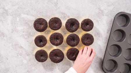 Photo for Flat lay. Step by step. Cooling freshly baked chocolate cupcakes to be decorated with buttercream frosting. - Royalty Free Image