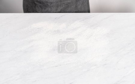 Photo for Kitchen counter covered with white flour for rolling the dough. - Royalty Free Image